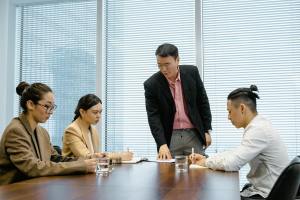 man in black coat talking at the meeting